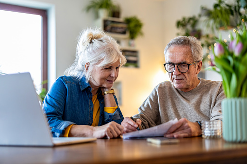 Senior couple sitting at the table discussing home finances